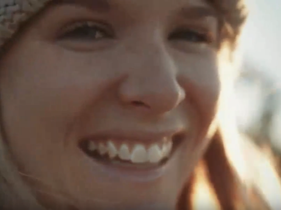 close up of cute blonde girl smiling at sunset